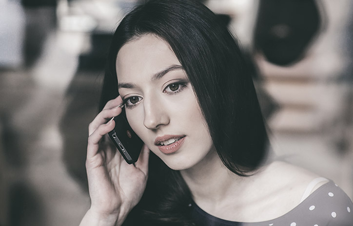 Beautiful girl talking on the phone and smiling
